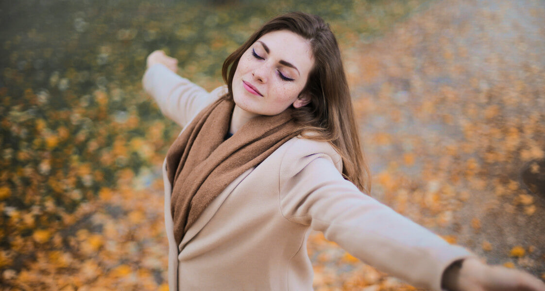 Woman with shiny long hair enjoying a fall day in the park