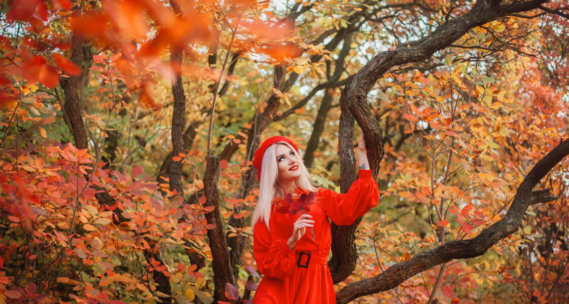 Blonde woman with beautiful, glossy hair enjoying a fall day